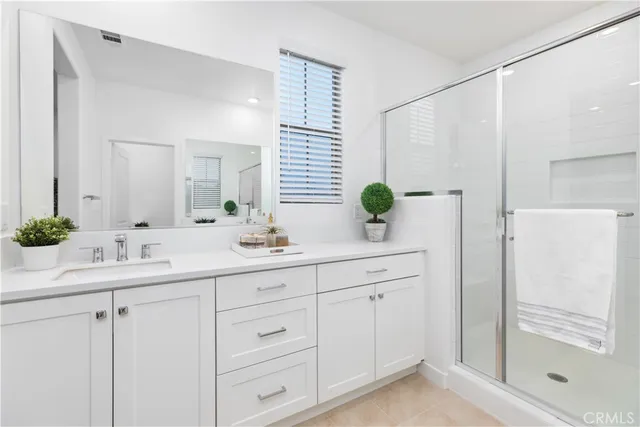 a bathroom with a double vanity sink and mirror
