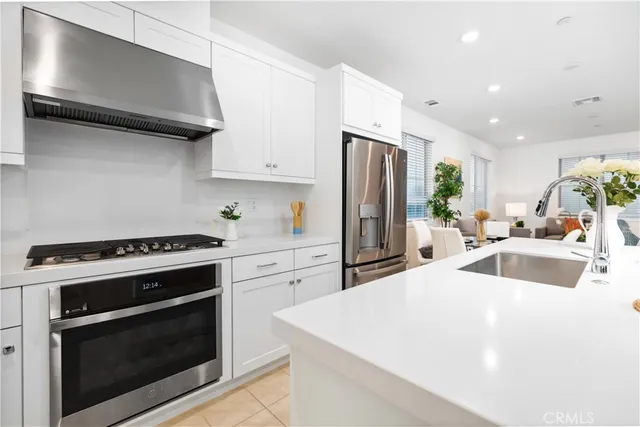 a kitchen with a stove a refrigerator and a sink