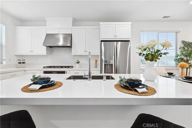 a kitchen with a sink a stove and refrigerator