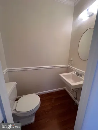 a bathroom with a sink toilet and a mirror