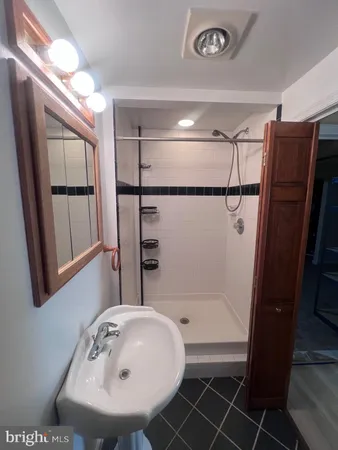 a bathroom with a sink and shower