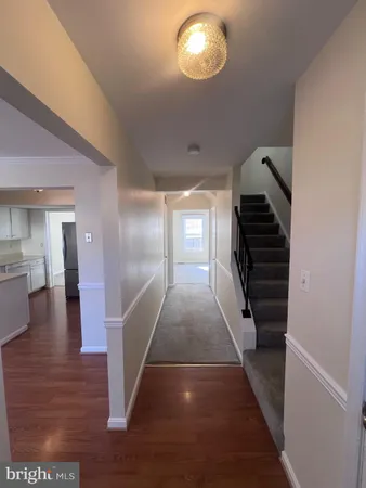 a view of entryway and hall with wooden floor