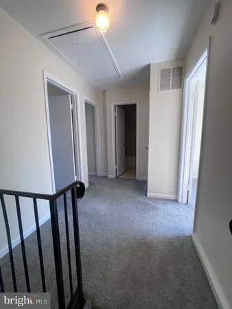 a view of a hallway with window in a room