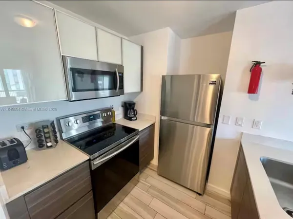 a kitchen with a refrigerator stove and microwave