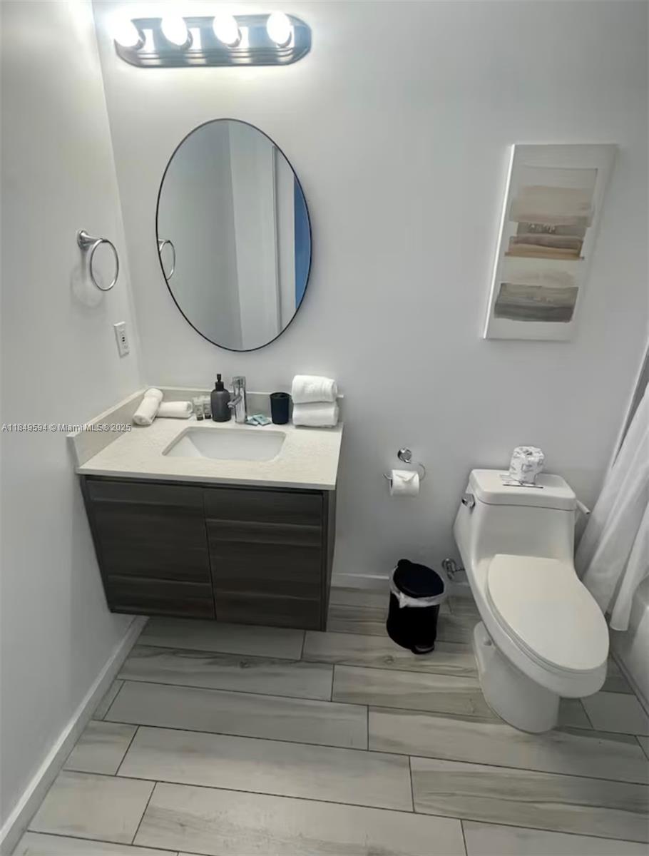 481 Northeast 29th Street, Unit 705 Miami, FL 33137 - Photo 11 of 14 a bathroom with a toilet sink and mirror