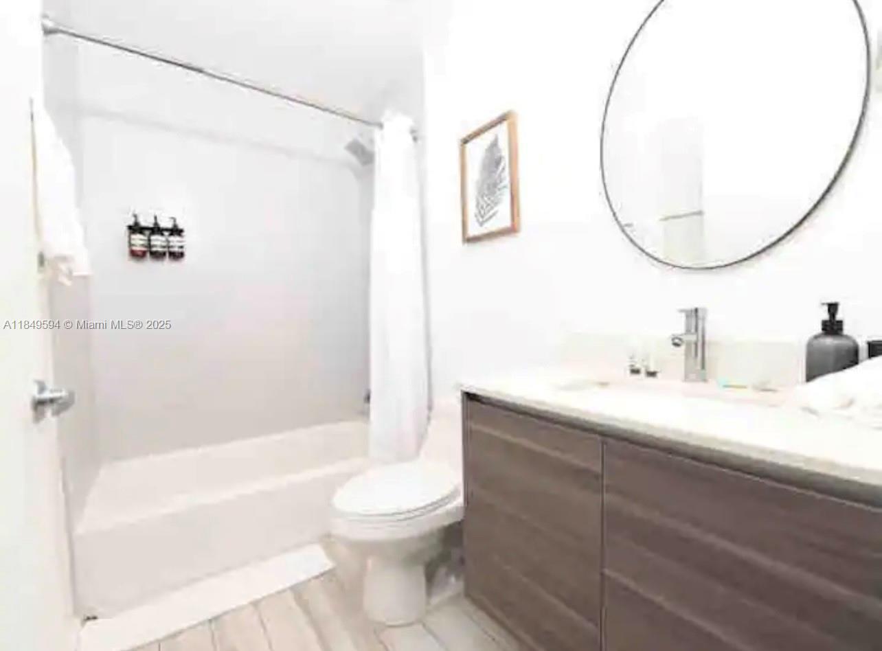 481 Northeast 29th Street, Unit 705 Miami, FL 33137 - Photo 13 of 14 a bathroom with a sink a toilet and a mirror