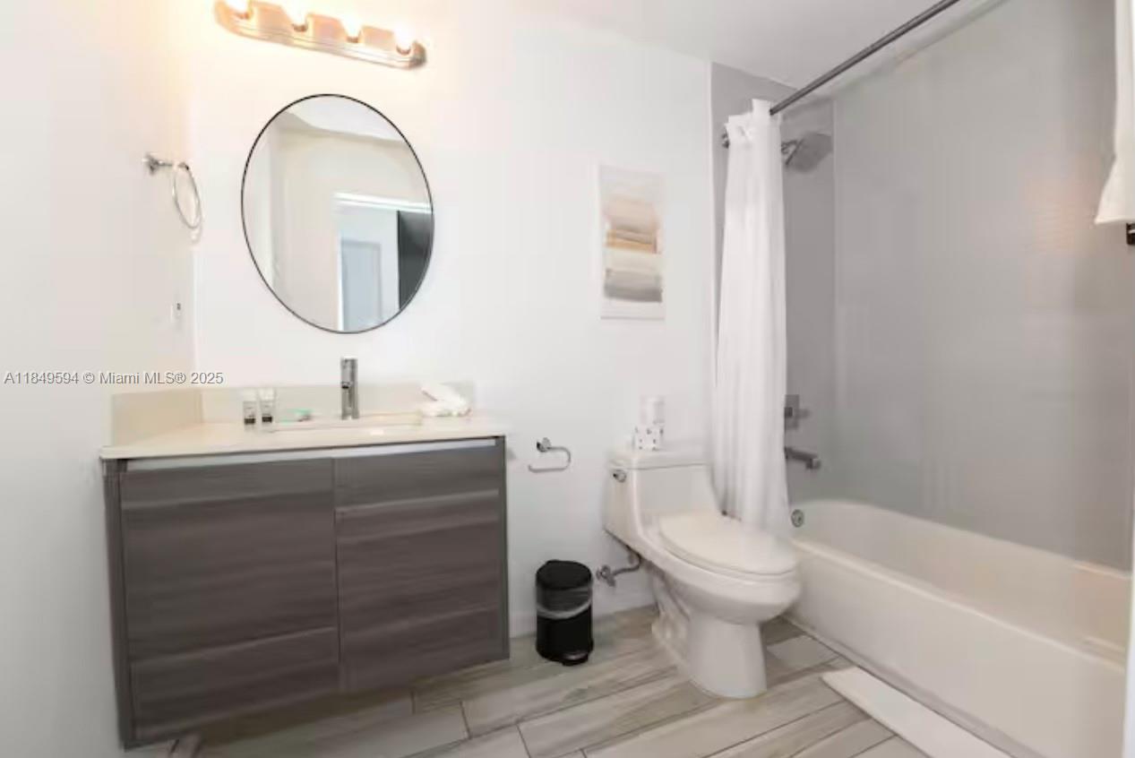 481 Northeast 29th Street, Unit 705 Miami, FL 33137 - Photo 14 of 14 a bathroom with a sink mirror bathtub and toilet