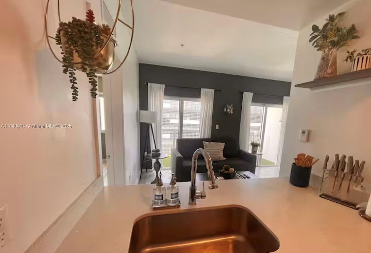 481 Northeast 29th Street, Unit 705 Miami, FL 33137 - Photo 3 of 14 a room with furniture and a chandelier