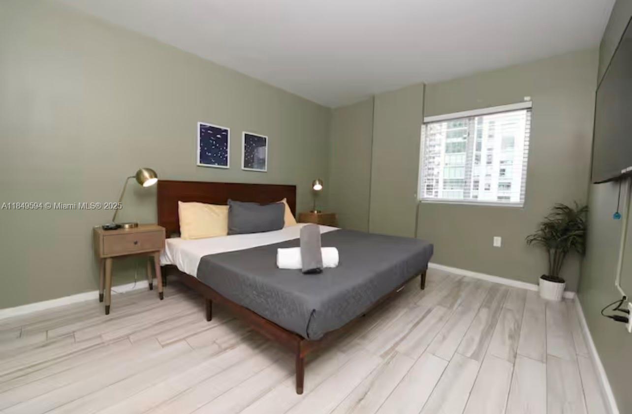 481 Northeast 29th Street, Unit 705 Miami, FL 33137 - Photo 8 of 14 a living room with a bed furniture and a window