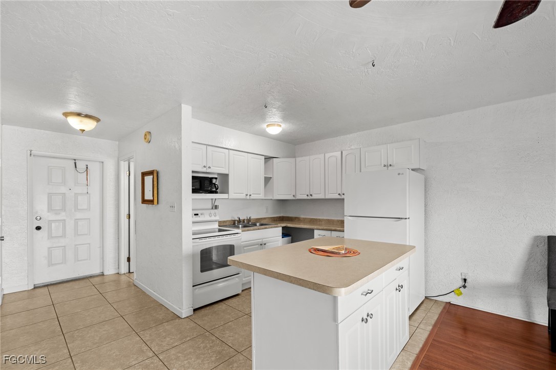 a kitchen with a stove a refrigerator and a sink
