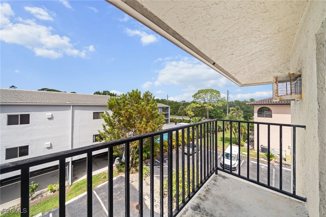 830 Wiggins Pass Road, Unit 14 Naples, FL 34110 - Photo 14 of 20 a view of a balcony with a plants and wooden fence