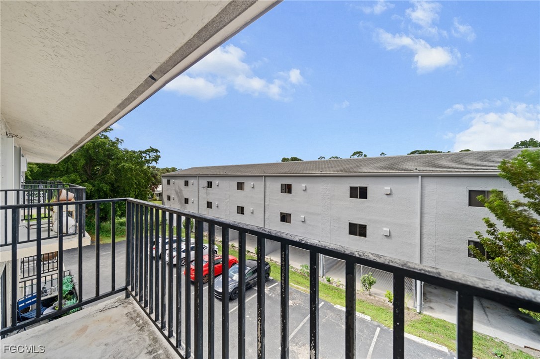 830 Wiggins Pass Road, Unit 14 Naples, FL 34110 - Photo 15 of 20 a view of a balcony with wooden fence