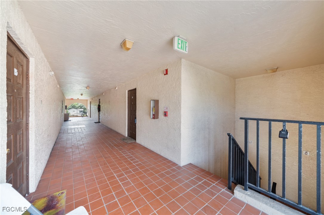 830 Wiggins Pass Road, Unit 14 Naples, FL 34110 - Photo 16 of 20 a view of a hallway with wooden floor