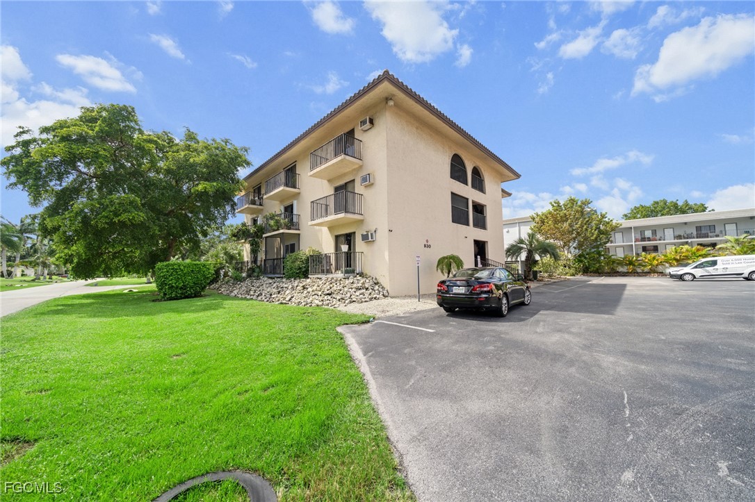 830 Wiggins Pass Road, Unit 14 Naples, FL 34110 - Photo 19 of 20 a view of a house with a yard