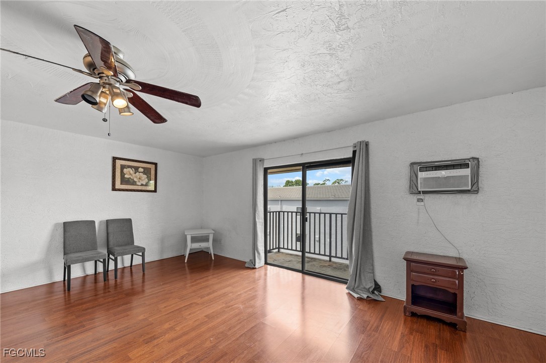 830 Wiggins Pass Road, Unit 14 Naples, FL 34110 - Photo 2 of 20 a view of a livingroom with furniture and wooden floor