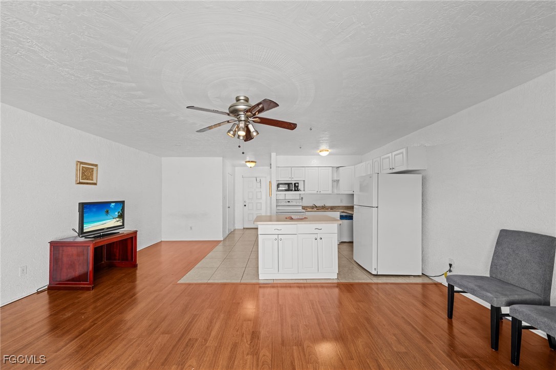 830 Wiggins Pass Road, Unit 14 Naples, FL 34110 - Photo 4 of 20 a living room with stainless steel appliances furniture and a kitchen view