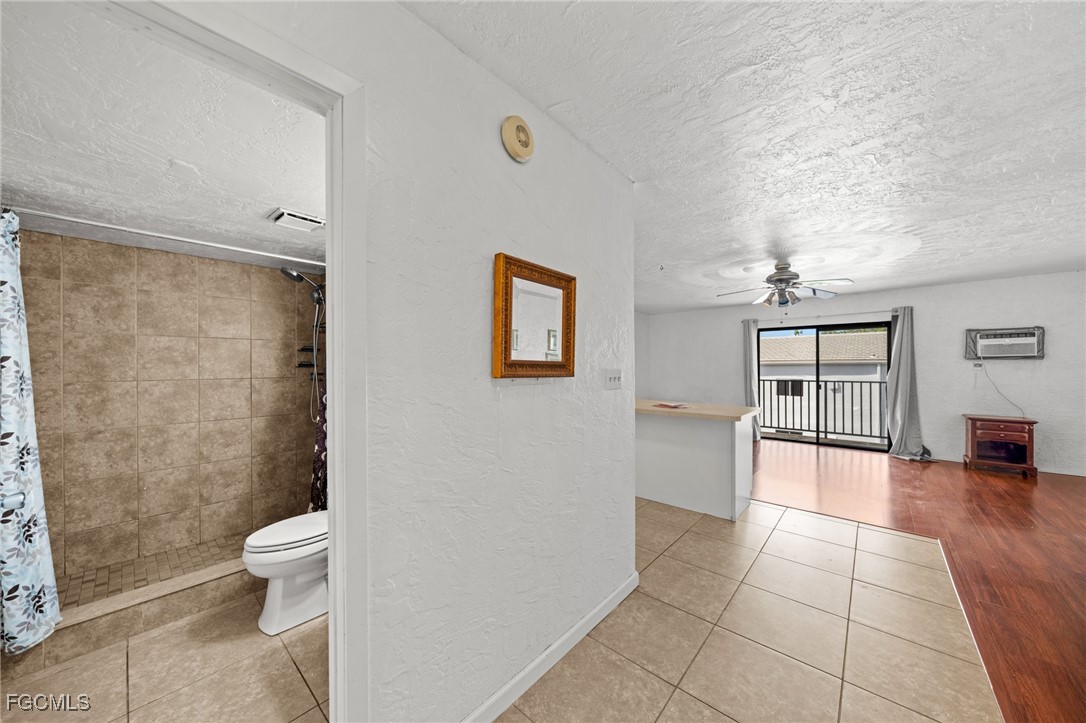 830 Wiggins Pass Road, Unit 14 Naples, FL 34110 - Photo 10 of 20 a bathroom with a toilet and a shower