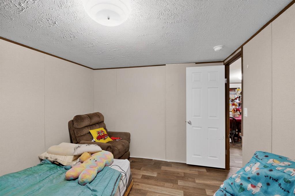 7219 Rucker Street Azle, TX 76020 - Photo 12 of 16 a room with toys and wooden floor