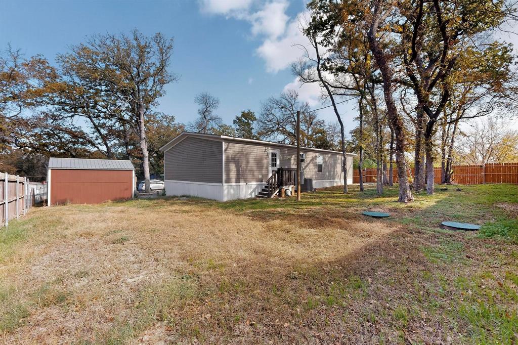 7219 Rucker Street Azle, TX 76020 - Photo 16 of 16 a backyard of a house with lots of green space