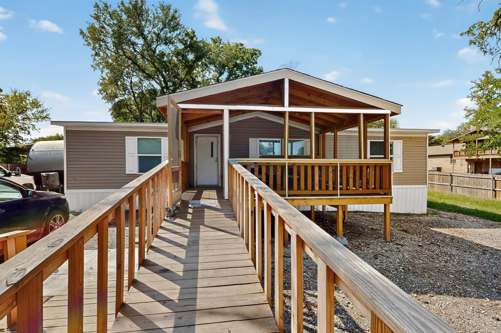 7219 Rucker Street Azle, TX 76020 - Photo 2 of 16 a view of wooden house with a deck and wooden floor