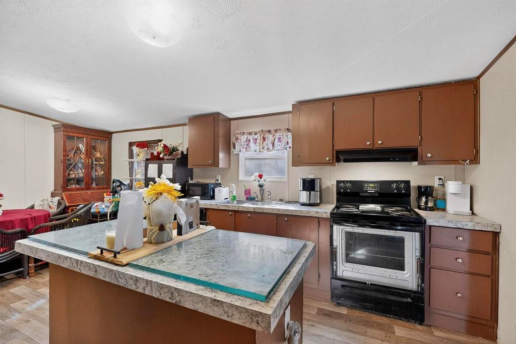 7219 Rucker Street Azle, TX 76020 - Photo 7 of 16 a kitchen with a stove a sink and a refrigerator