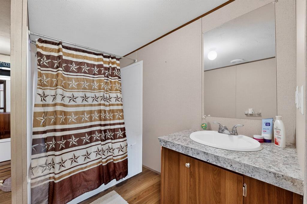 7219 Rucker Street Azle, TX 76020 - Photo 10 of 16 a bathroom with a granite countertop sink and a mirror