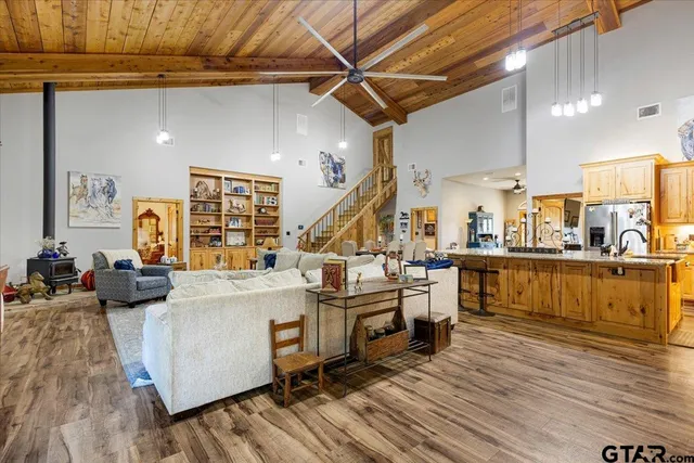 a view of a kitchen with furniture and wooden floor
