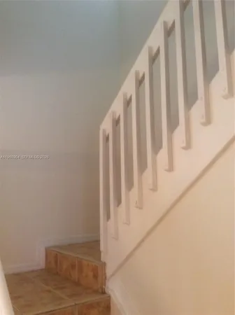 a view of staircase with white walls