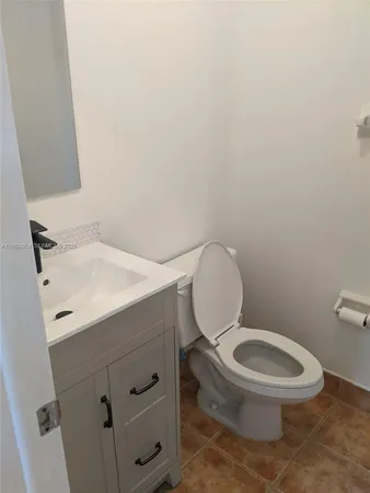 a white toilet sitting next to a bathroom sink