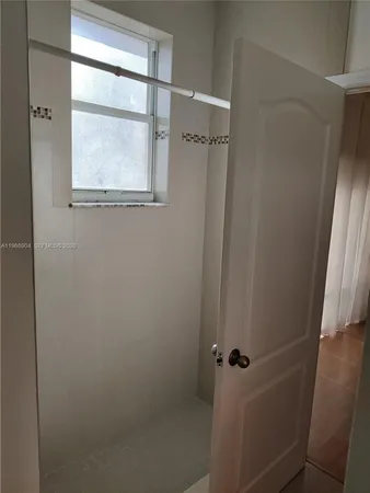 a bathroom with a glass shower door