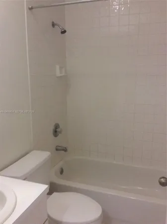 a bathroom with a toilet and shower
