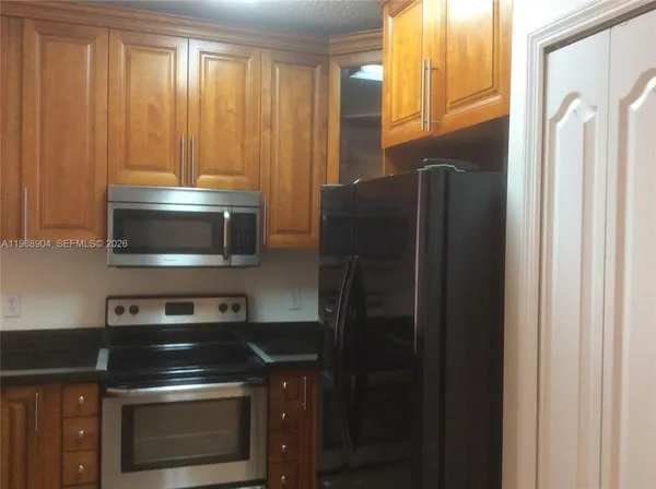a kitchen with a refrigerator stove and microwave