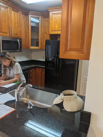 a kitchen with a sink cabinets and window