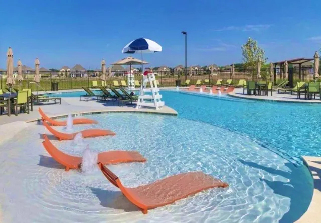 a swimming pool with some trees in the background