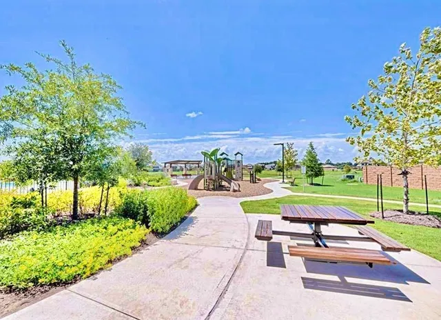 a large white kitchen with kitchen island a sink a stove a refrigerator and a stove with wooden floor