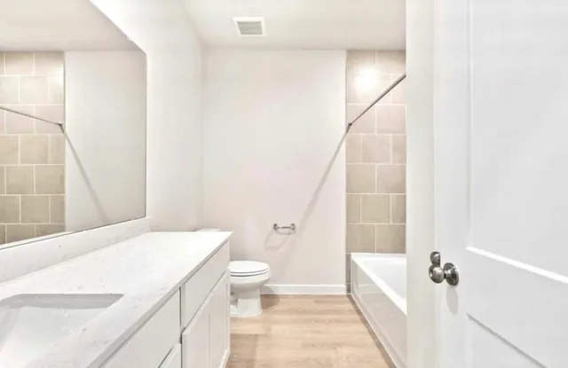 an empty room with a window and a ceiling fan