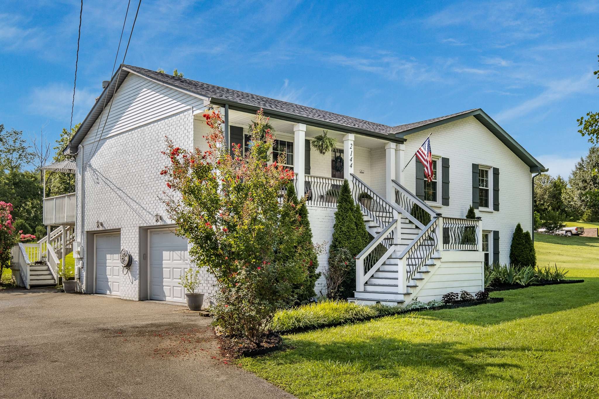 2144 Osburn Road Arrington, TN 37014 - Photo 7 of 51 a front view of a house with a garden and trees