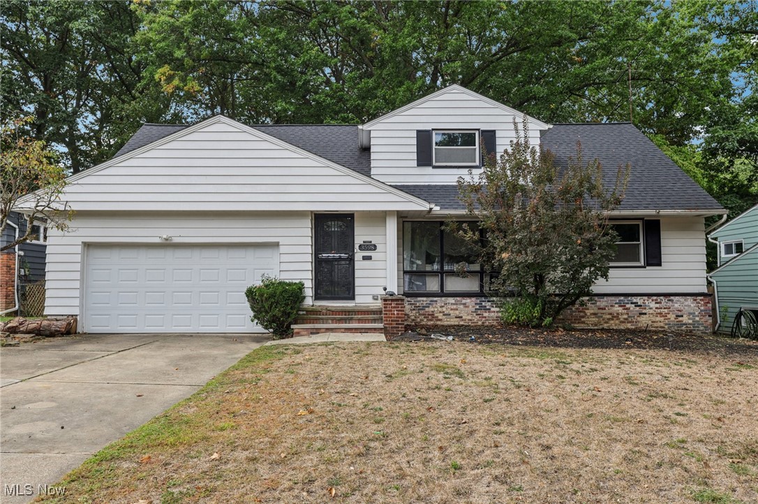3598 Atherstone Road Cleveland, OH 44121 - Photo 1 of 18 Traditional home with roof with shingles, a front yard, concrete driveway, and brick siding