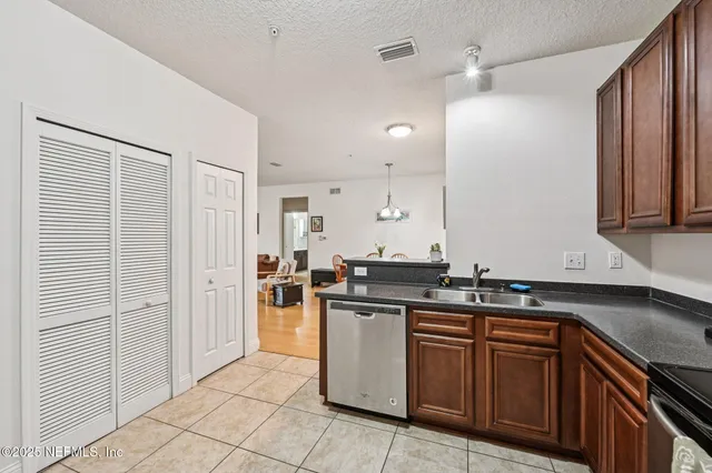 a kitchen with stainless steel appliances granite countertop a sink and a stove