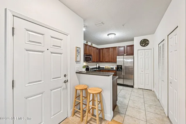a kitchen with stainless steel appliances granite countertop a refrigerator and a sink