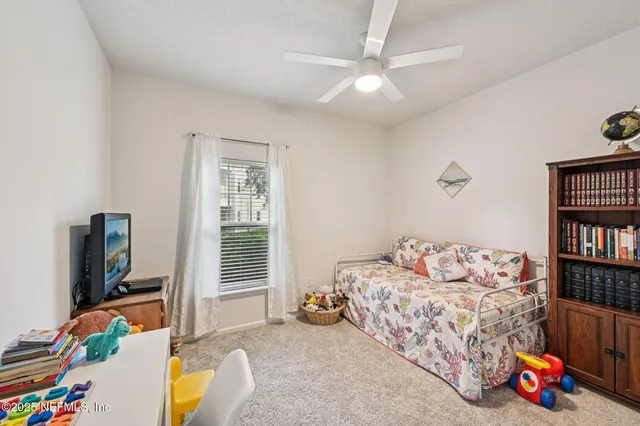 a bedroom with bed and a book shelf