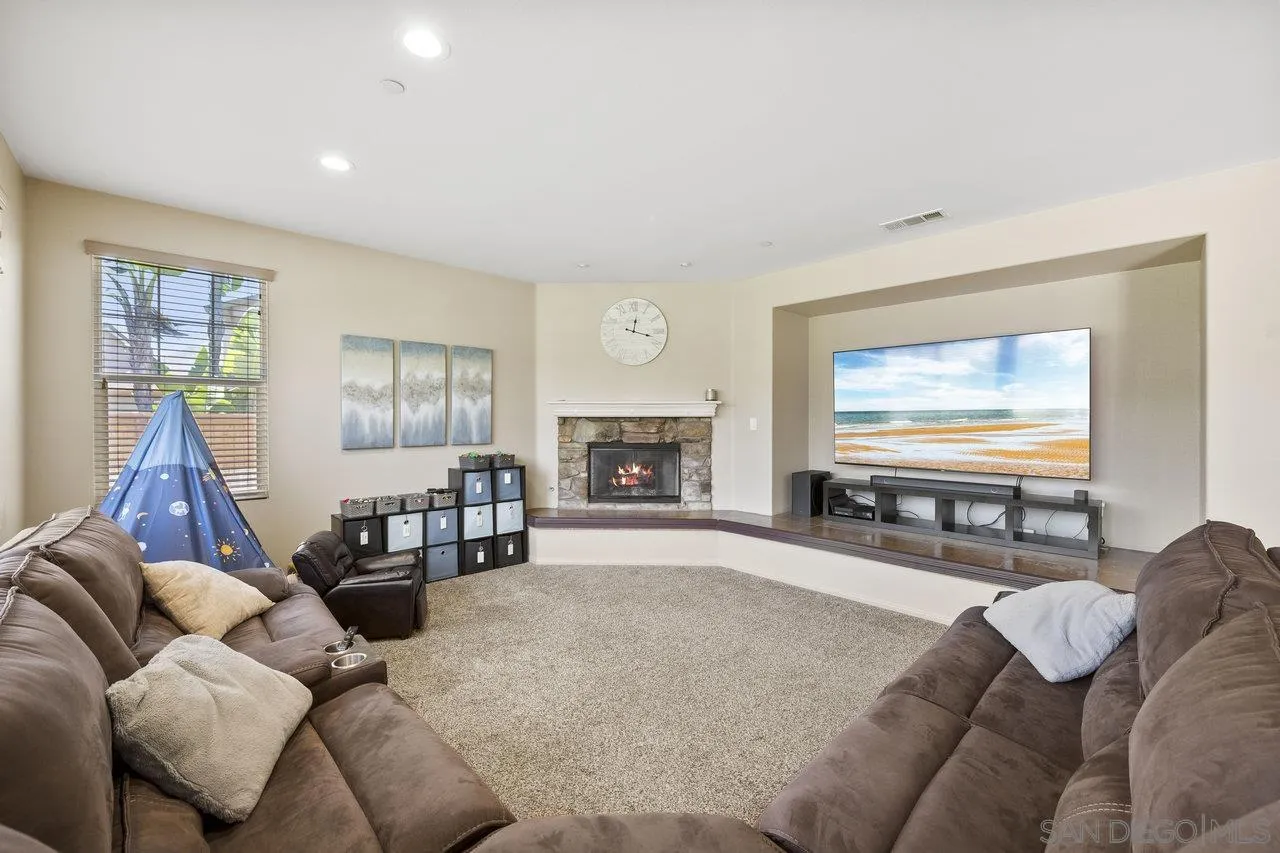 2928 Burnet Drive Escondido, CA 92027 - Photo 15 of 39 a living room with furniture a large window and a fireplace