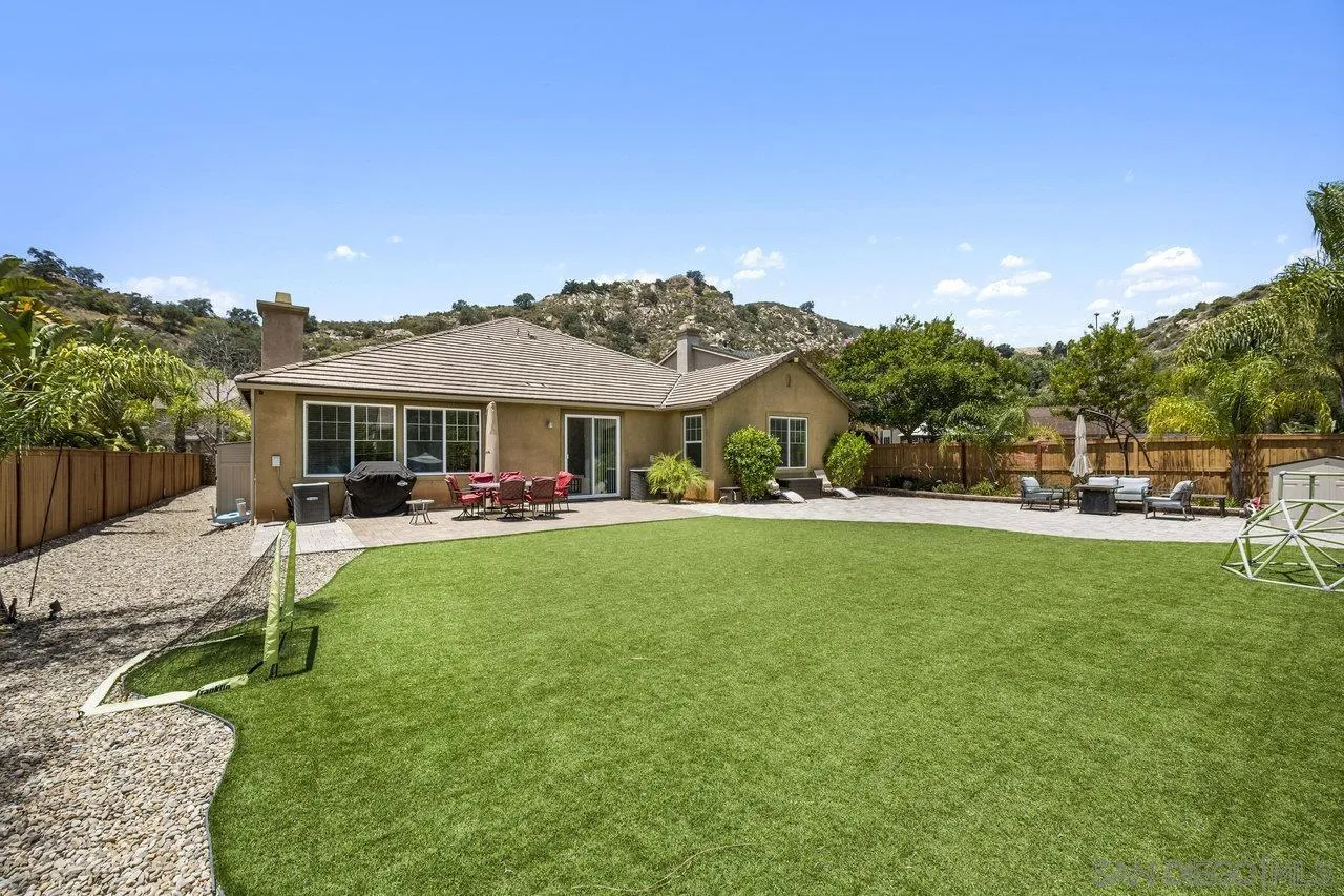 2928 Burnet Drive Escondido, CA 92027 - Photo 2 of 39 a patio with a table and chairs under an umbrella