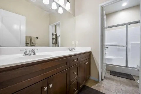 a bathroom with a double vanity sink and a mirror