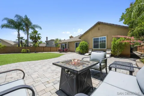 a view of backyard of house with outdoor seating