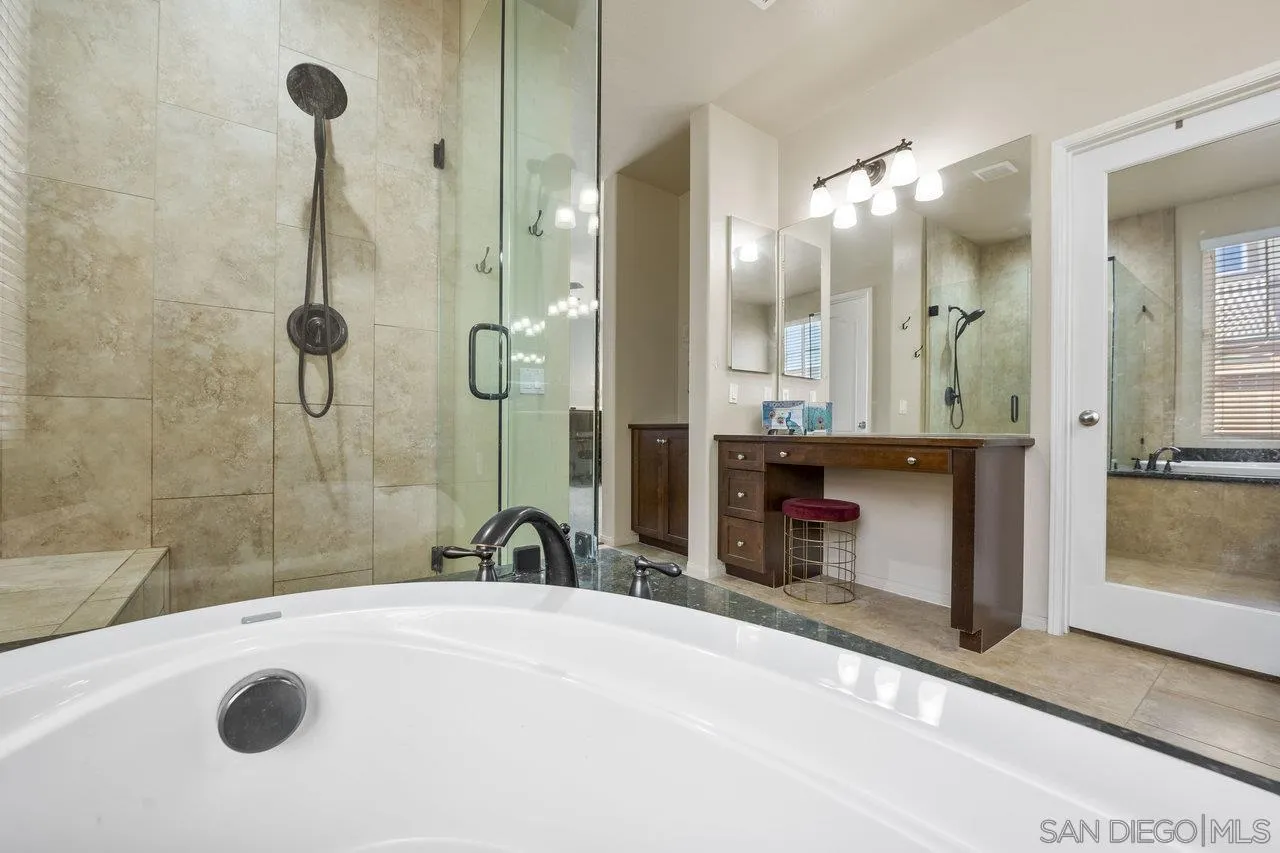 2928 Burnet Drive Escondido, CA 92027 - Photo 4 of 39 a bathroom with a sink a mirror and a shower