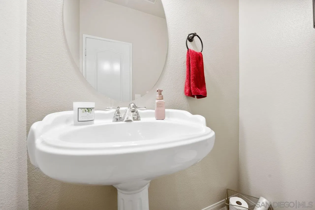 2928 Burnet Drive Escondido, CA 92027 - Photo 10 of 39 a bathroom with a sink and mirror