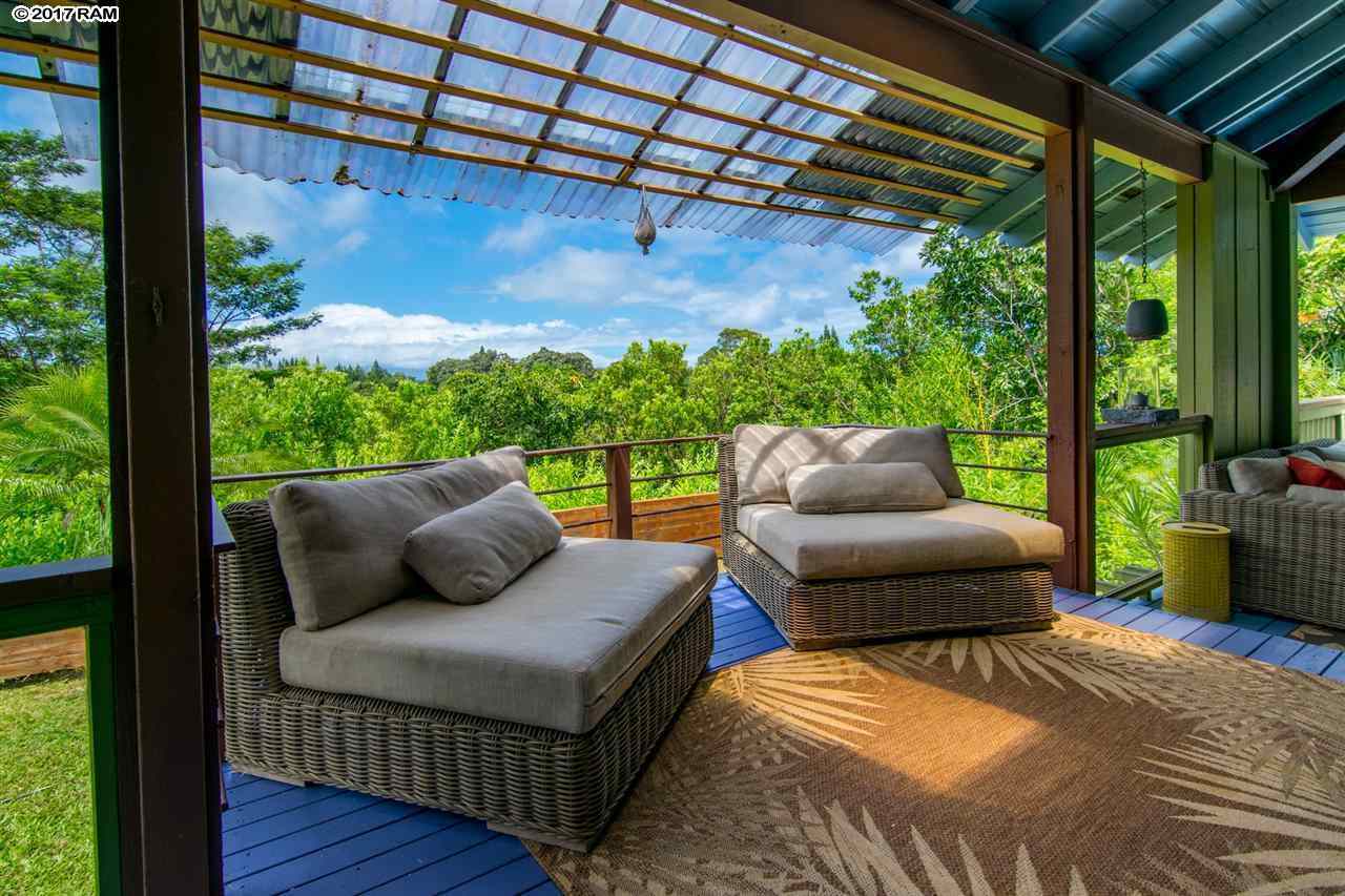 690 East Kuiaha Road Haiku, HI 96708 - Photo 13 of 30 a balcony view with a couch and wooden floor