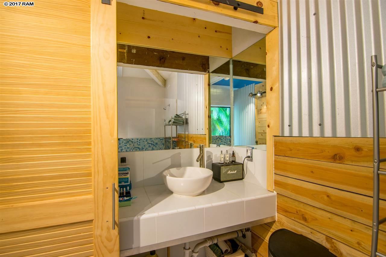 690 East Kuiaha Road Haiku, HI 96708 - Photo 22 of 30 a bathroom with a sink and a mirror