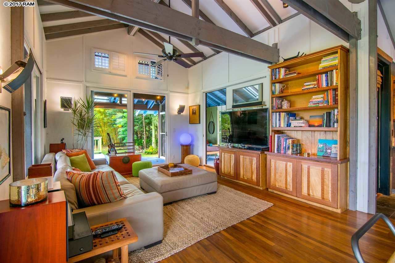 690 East Kuiaha Road Haiku, HI 96708 - Photo 9 of 30 a living room with furniture a flat screen tv and a floor to ceiling window